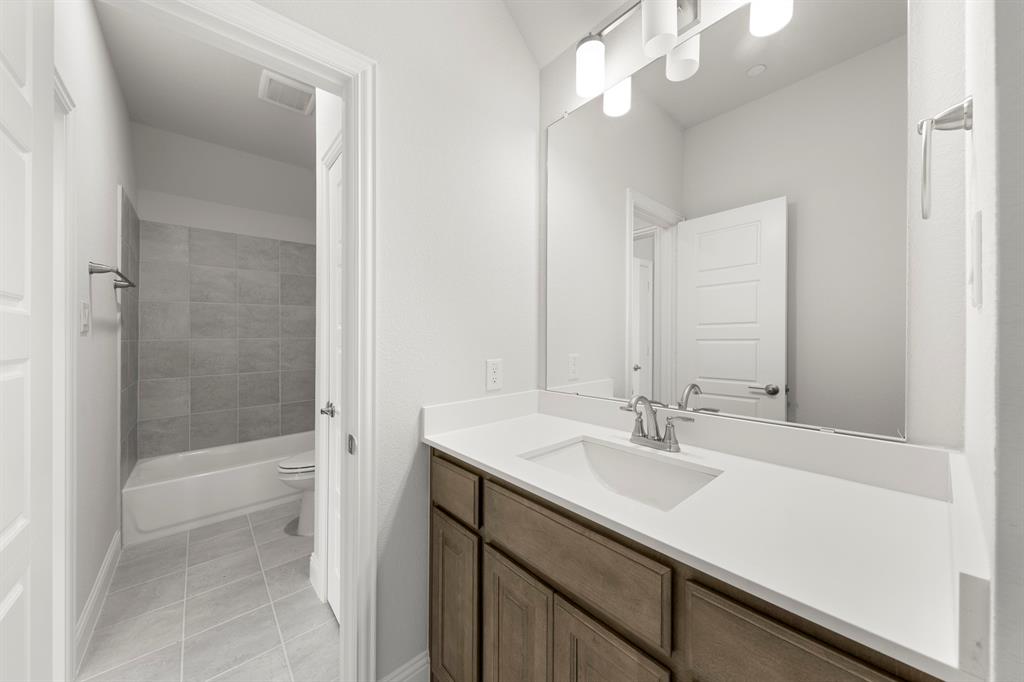 403 Spoonbill Road Sunnyvale, TX 75182 - Photo 28 of 34 a bathroom with a sink a shower and a mirror