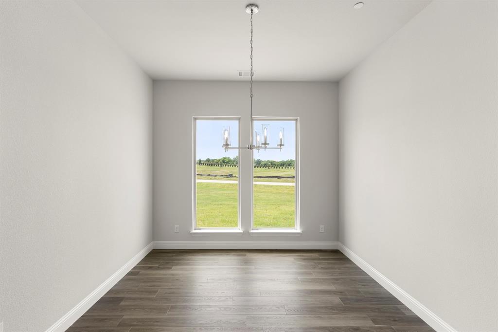 403 Spoonbill Road Sunnyvale, TX 75182 - Photo 4 of 34 a view of a kitchen with wooden floor and a window