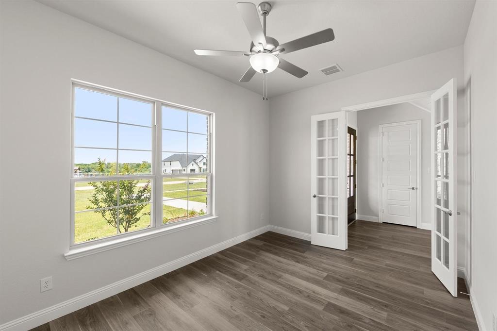 403 Spoonbill Road Sunnyvale, TX 75182 - Photo 5 of 34 a view of an empty room with window and wooden floor