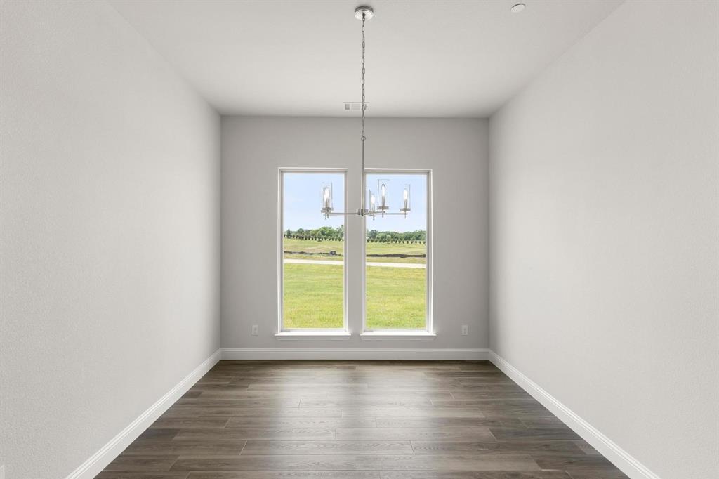 403 Spoonbill Road Sunnyvale, TX 75182 - Photo 6 of 34 a view of a kitchen with wooden floor and a window