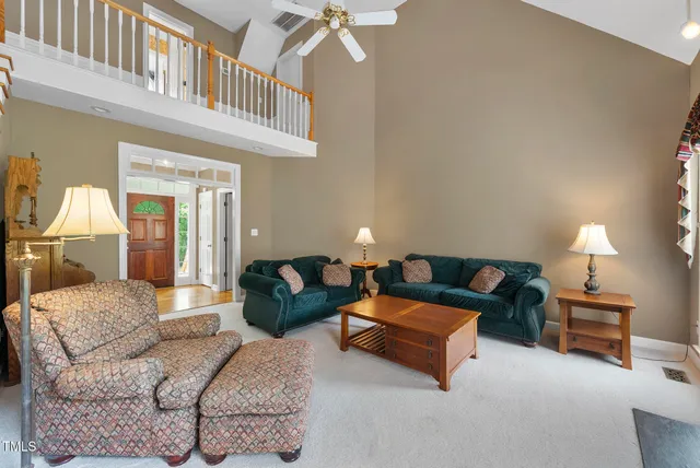a living room with furniture fireplace and a window