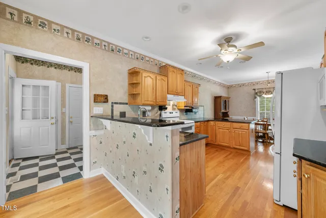 a living room with furniture a rug and a chandelier