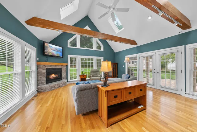 a living room with a large window and wooden floor
