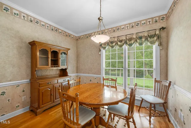 a view of a livingroom with furniture a fireplace and wooden floor