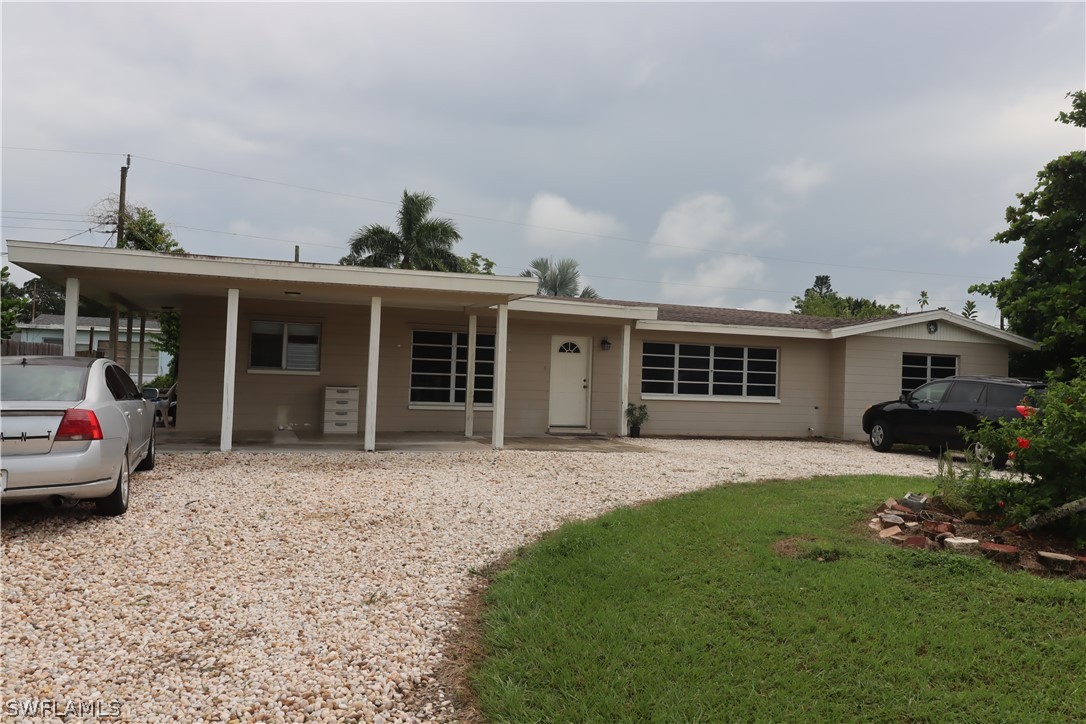 5529 Granada Road Fort Myers, FL 33919 - Photo 1 of 29 a front view of a house with a garden and patio