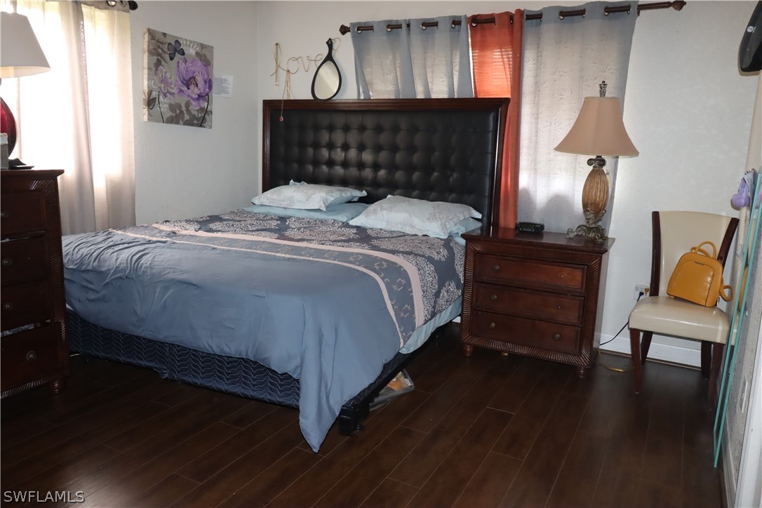 5529 Granada Road Fort Myers, FL 33919 - Photo 14 of 29 a bed sitting in a bedroom next to a lamp