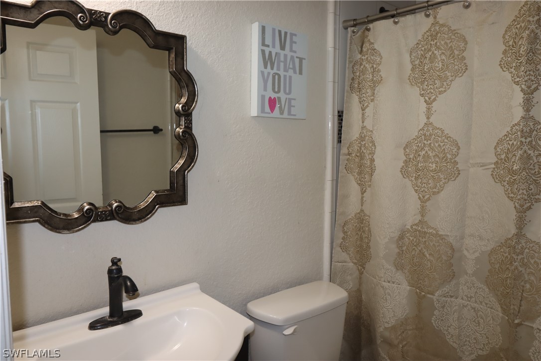 5529 Granada Road Fort Myers, FL 33919 - Photo 15 of 29 a bathroom with a toilet and a sink
