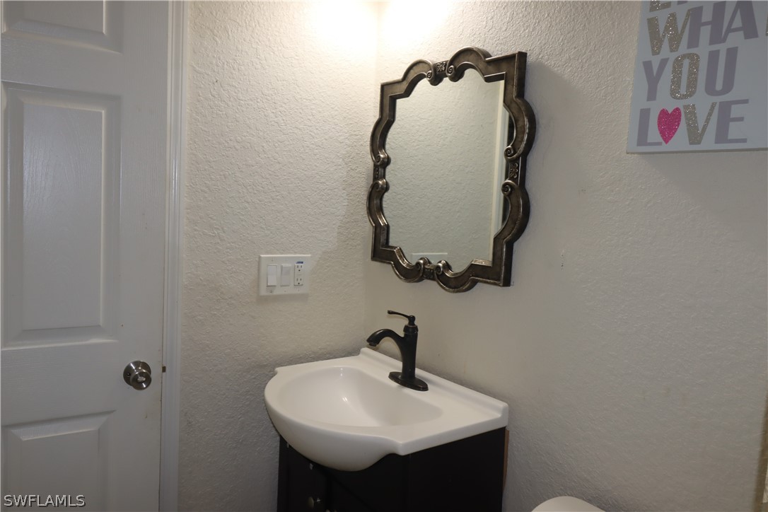 5529 Granada Road Fort Myers, FL 33919 - Photo 16 of 29 a bathroom with a sink and mirror