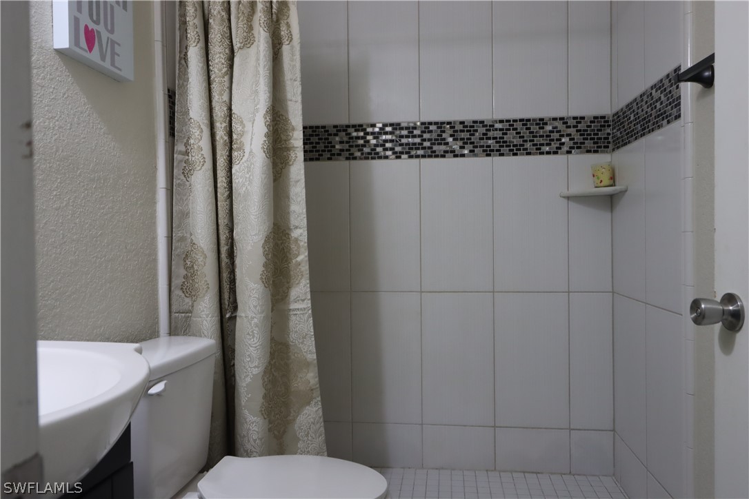 5529 Granada Road Fort Myers, FL 33919 - Photo 17 of 29 a bathroom with a toilet and a shower