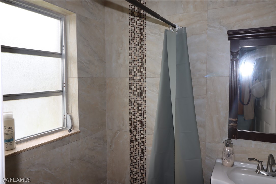 5529 Granada Road Fort Myers, FL 33919 - Photo 20 of 29 a bathroom with a shower and a sink