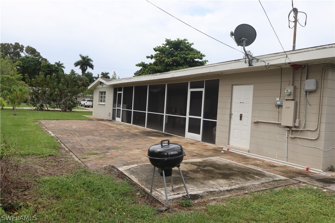 5529 Granada Road Fort Myers, FL 33919 - Photo 25 of 29 a front view of a house with a yard and fountain