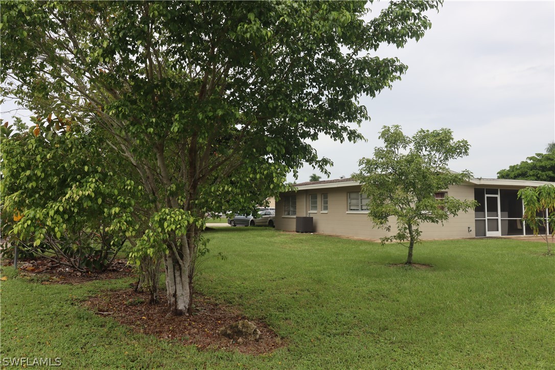 5529 Granada Road Fort Myers, FL 33919 - Photo 29 of 29 a view of a house with a tree in a yard