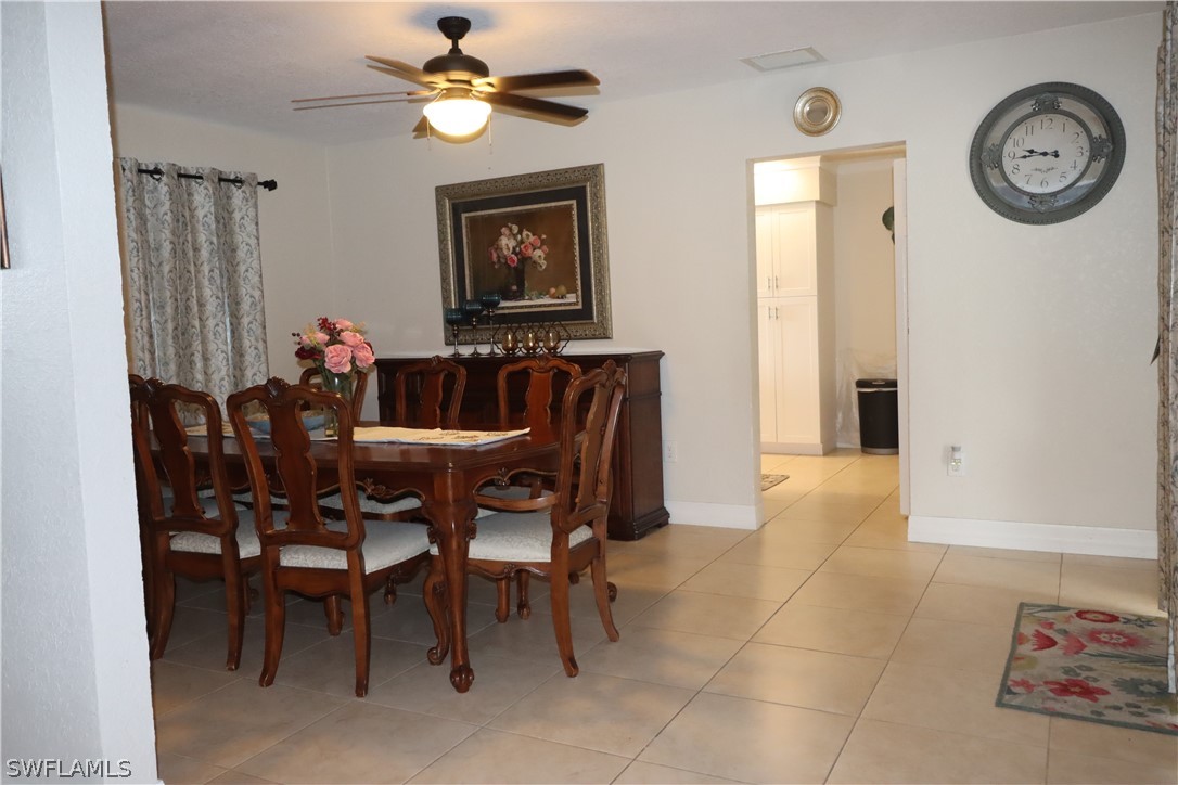 5529 Granada Road Fort Myers, FL 33919 - Photo 6 of 29 a view of a dining room with furniture and a chandelier fan