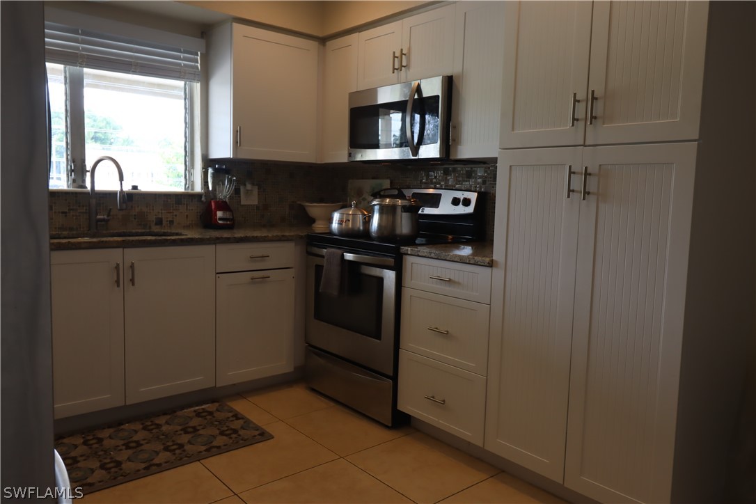 5529 Granada Road Fort Myers, FL 33919 - Photo 8 of 29 a kitchen with stainless steel appliances granite countertop a sink stove and cabinets