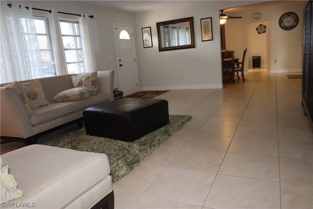 5529 Granada Road Fort Myers, FL 33919 - Photo 10 of 29 a living room with couches and a large window with rug floor