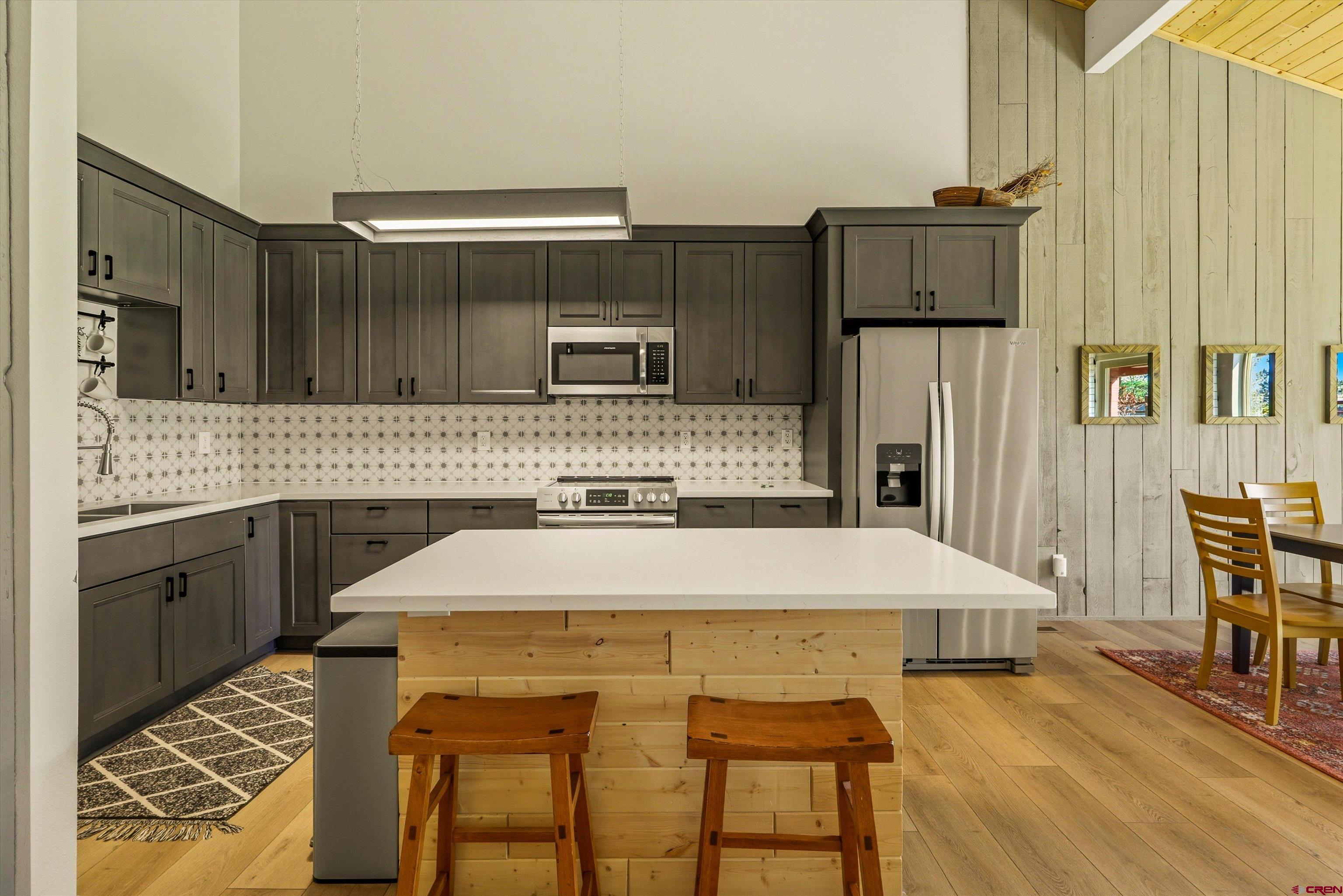 217 Pinon Causeway, Unit 3022 Pagosa Springs, CO 81147 - Photo 14 of 42 a kitchen with a table chairs and refrigerator