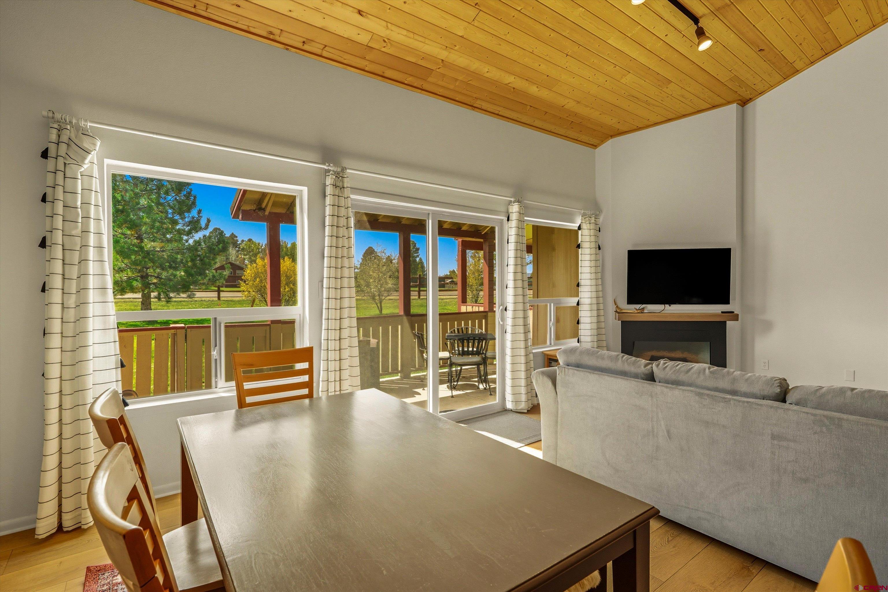 217 Pinon Causeway, Unit 3022 Pagosa Springs, CO 81147 - Photo 15 of 42 a living room with large window and a flat screen tv