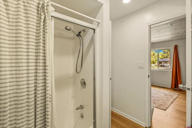 a bathroom with a shower and a mirror