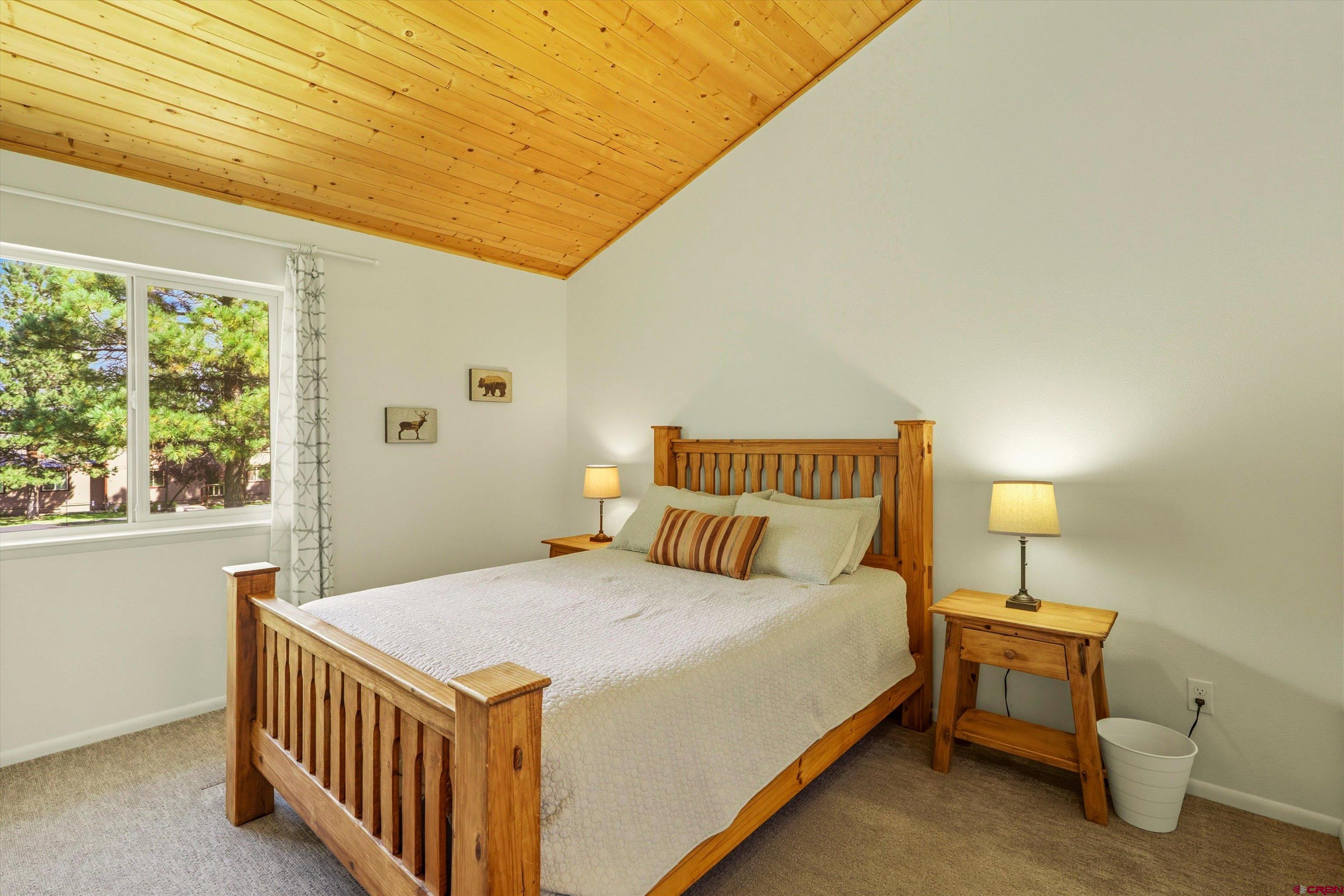 217 Pinon Causeway, Unit 3022 Pagosa Springs, CO 81147 - Photo 22 of 42 a bedroom with a bed and a window