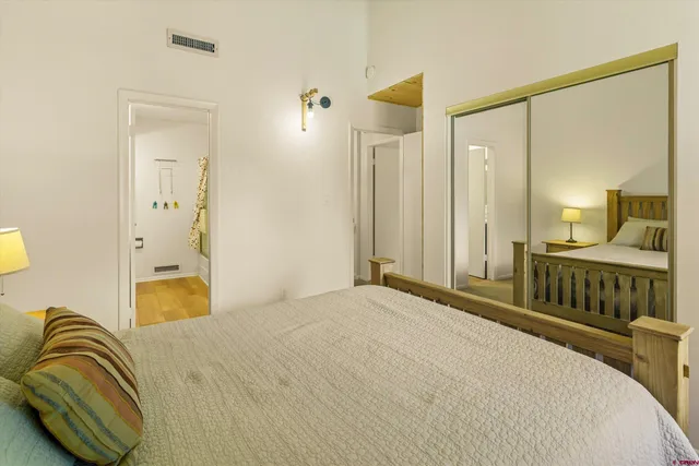 a bedroom with a bed and a mirror