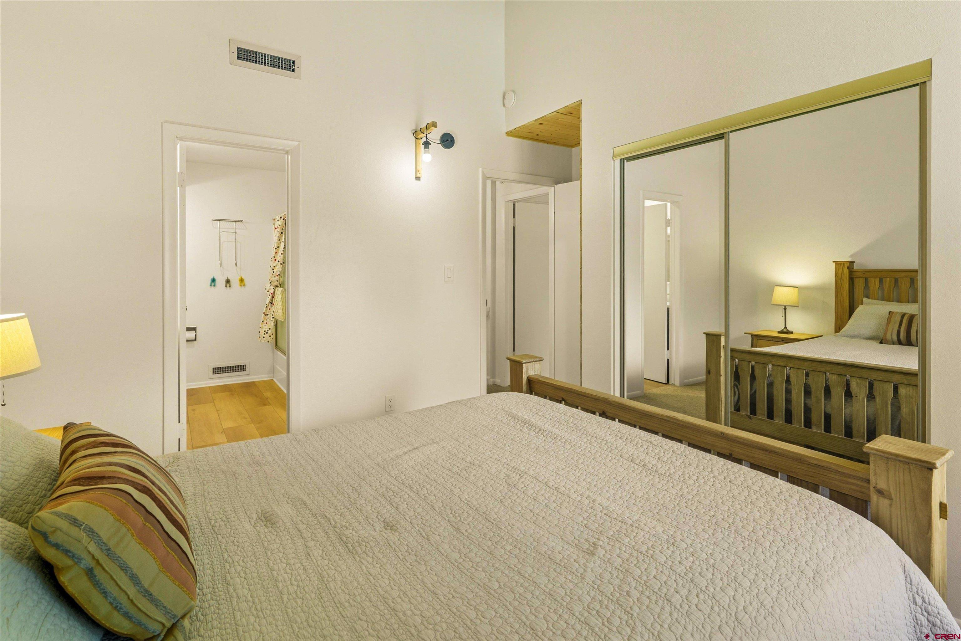 217 Pinon Causeway, Unit 3022 Pagosa Springs, CO 81147 - Photo 23 of 42 a bedroom with a bed and a mirror