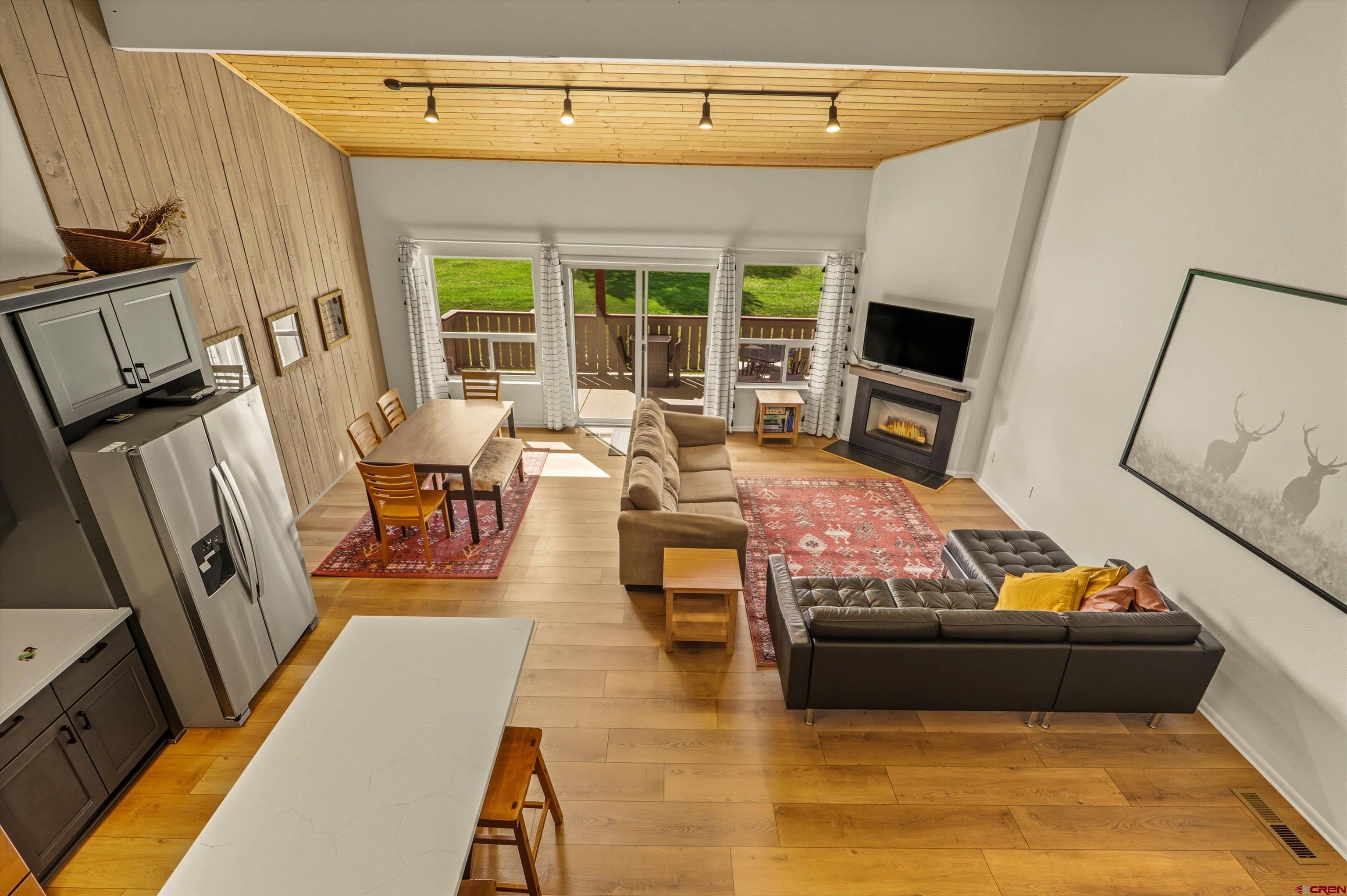 217 Pinon Causeway, Unit 3022 Pagosa Springs, CO 81147 - Photo 30 of 42 a living room with furniture stove and a flat screen tv