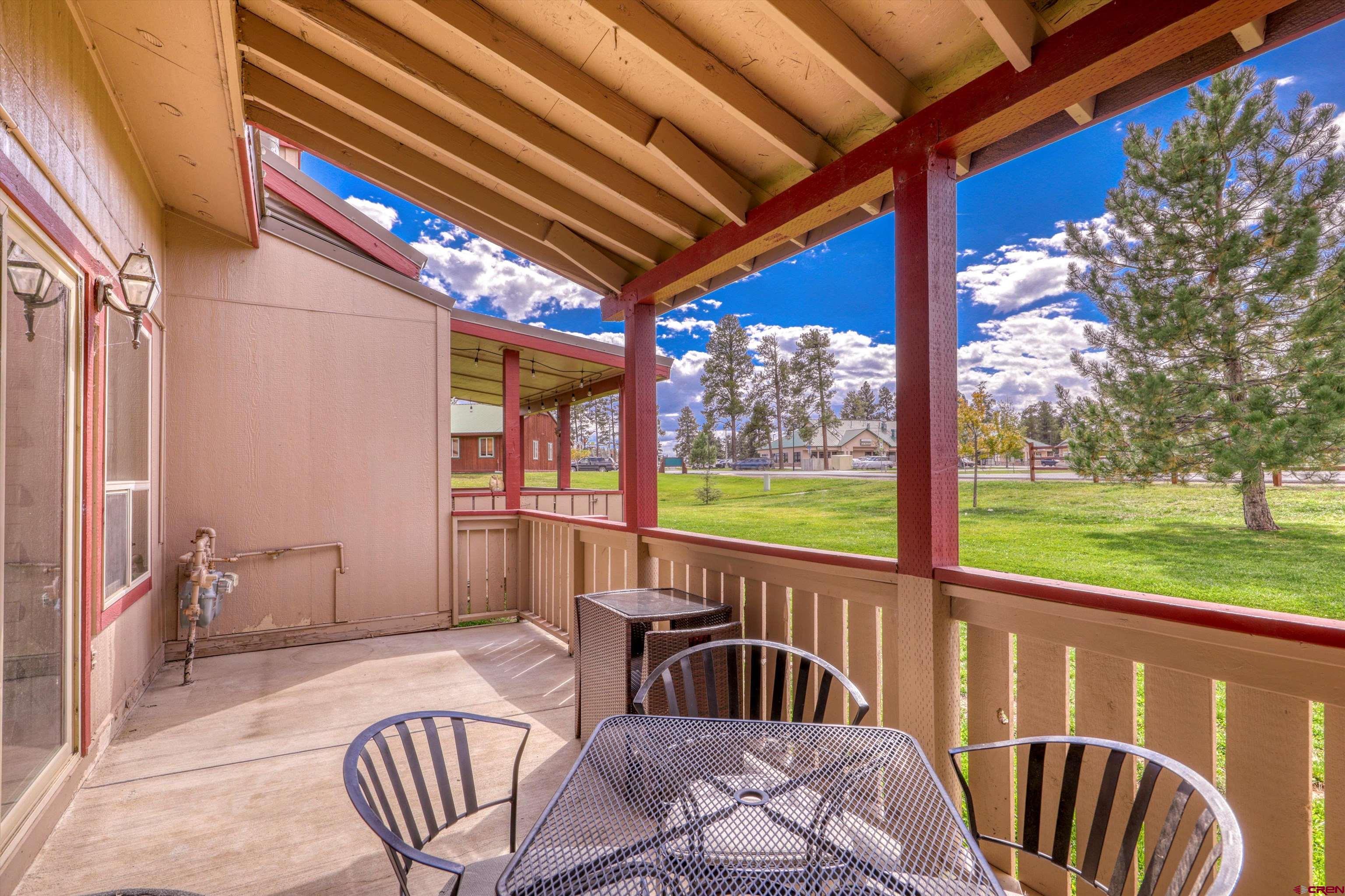 217 Pinon Causeway, Unit 3022 Pagosa Springs, CO 81147 - Photo 32 of 42 a view of a patio with a table chairs and a backyard