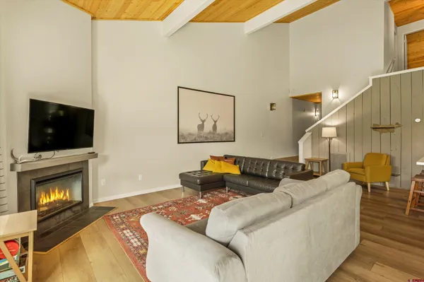 a living room with large window and a flat screen tv