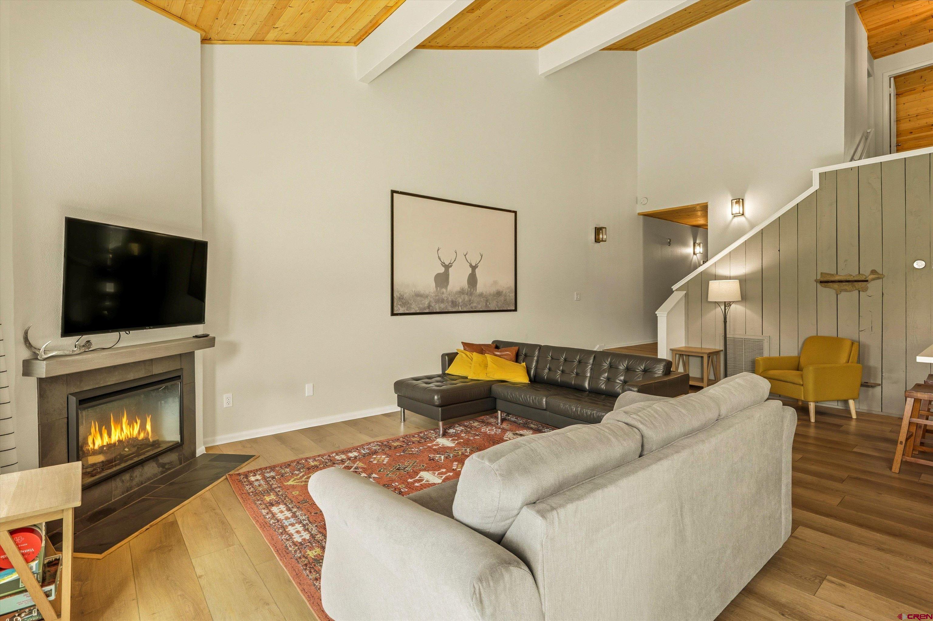 217 Pinon Causeway, Unit 3022 Pagosa Springs, CO 81147 - Photo 5 of 42 a living room with furniture fireplace and flat screen tv