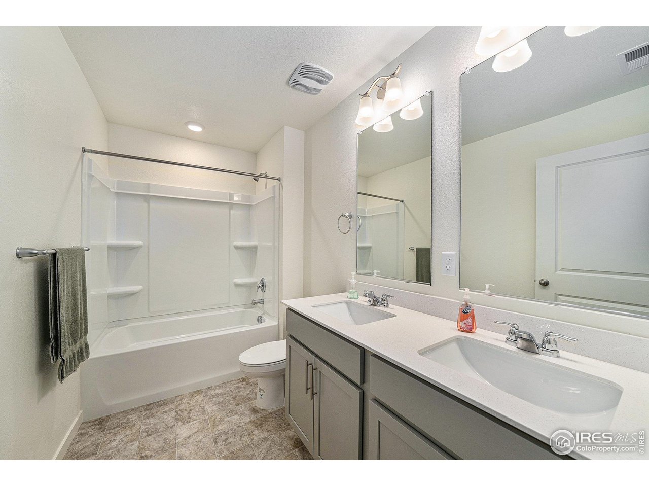 439 Bluebird Road Johnstown, CO 80534 - Photo 27 of 36 a bathroom with a sink double vanity granite tub shower and a mirror