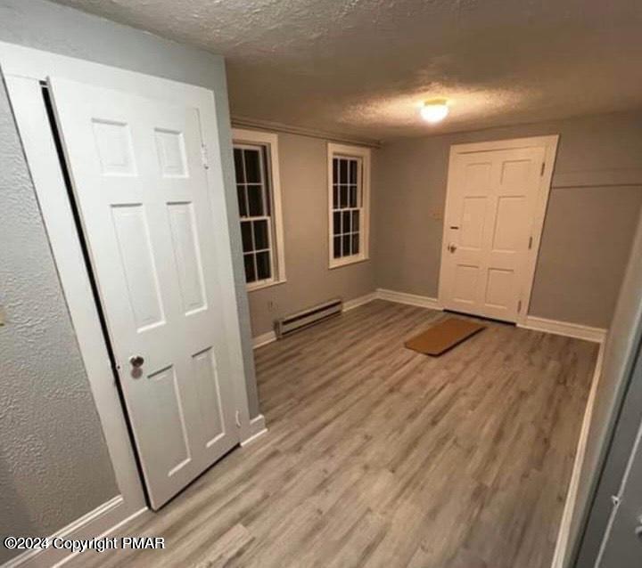 6663-6665 Highway 191 Cresco, PA 18326 - Photo 11 of 12 a view of empty room with wooden floor and fan