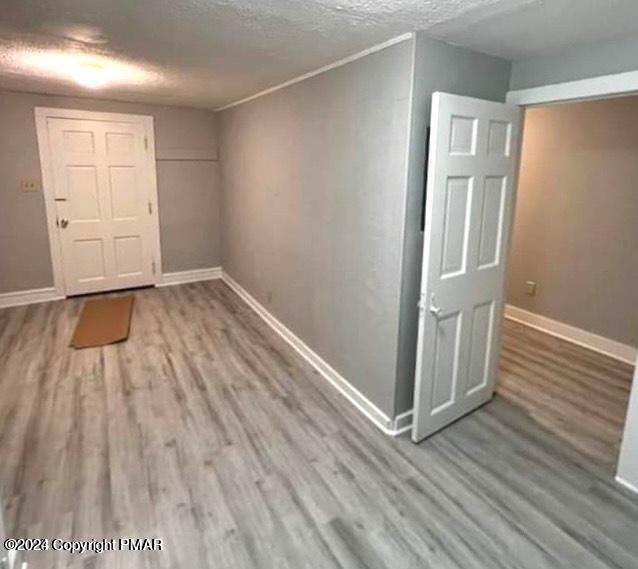 6663-6665 Highway 191 Cresco, PA 18326 - Photo 12 of 12 an empty room with wooden floor and windows
