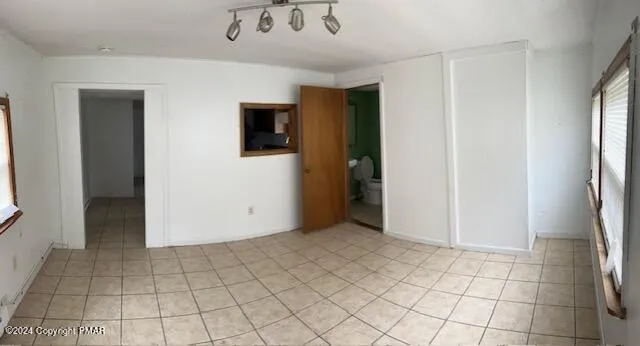 a view of a livingroom with an empty space and a window