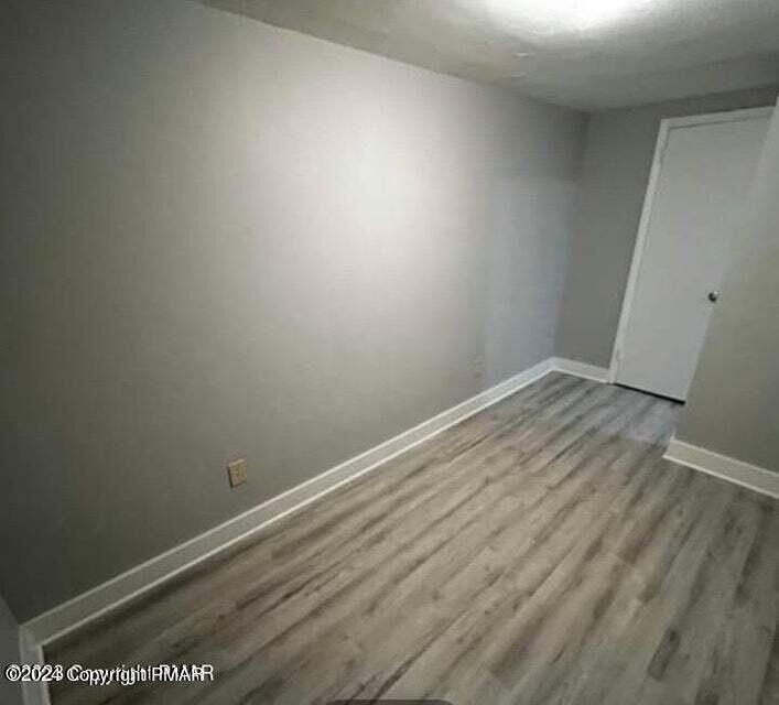 6663-6665 Highway 191 Cresco, PA 18326 - Photo 6 of 12 an empty room with wooden floor