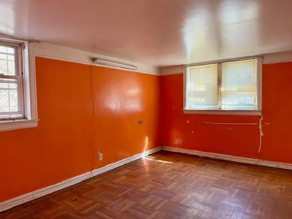 an empty room with a empty space and windows