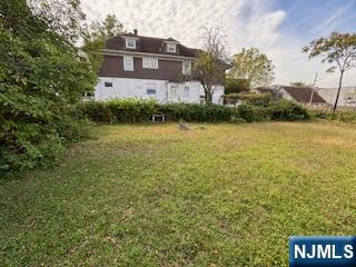 75 Cleveland Street Hackensack, NJ 07601 - Photo 11 of 12 a front view of a house with a yard