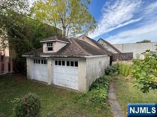 75 Cleveland Street Hackensack, NJ 07601 - Photo 12 of 12 a house with green field in front of it