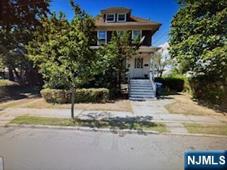 75 Cleveland Street Hackensack, NJ 07601 - Photo 6 of 12 a front view of a house with a yard and garage