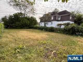 75 Cleveland Street Hackensack, NJ 07601 - Photo 10 of 12 a front view of a house with a yard