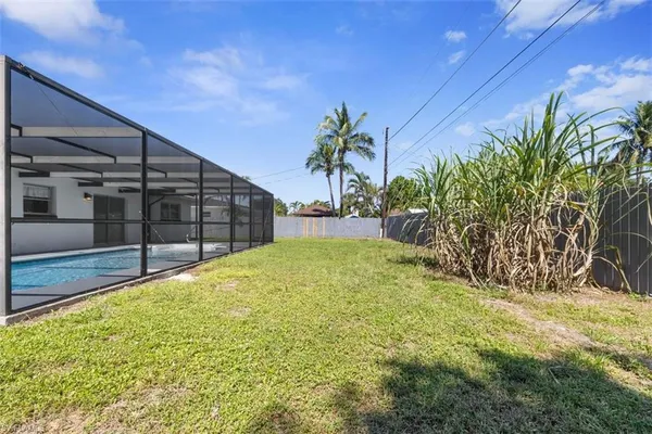 a large house with a large tree and a yard in front of it