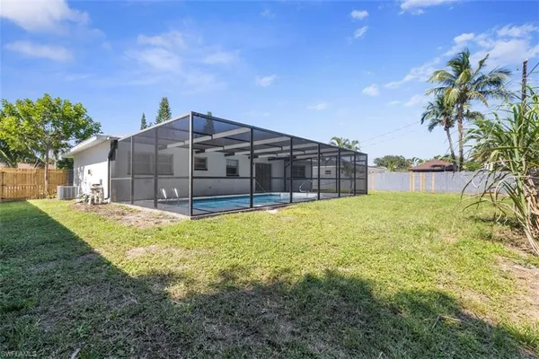 an aerial view of a house with a yard swimming pool and outdoor seating