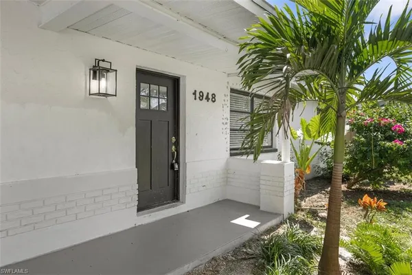 a backyard of a house with potted plants