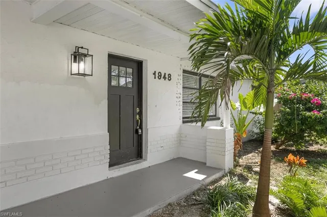 a backyard of a house with potted plants