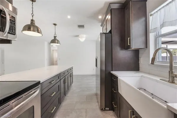 a kitchen with a sink and a refrigerator