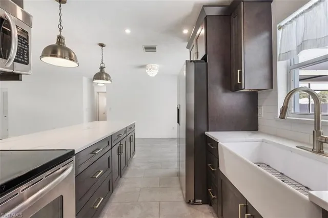 a kitchen with a sink and a refrigerator