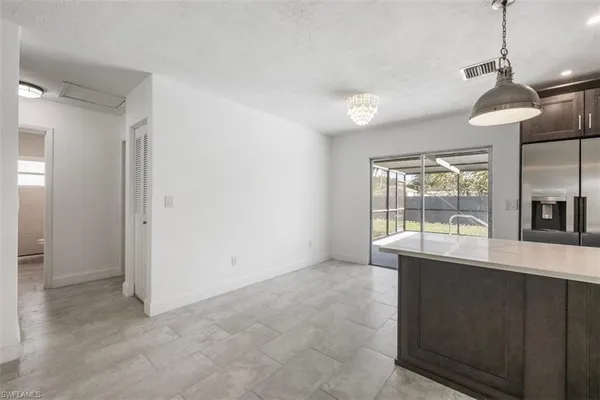a room with a window and a kitchen view