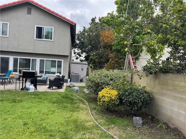 a view of a house with backyard porch and sitting area