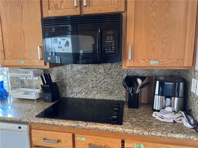 a kitchen with granite countertop a sink and a stove