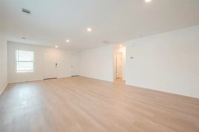 a view of an empty room with a kitchen