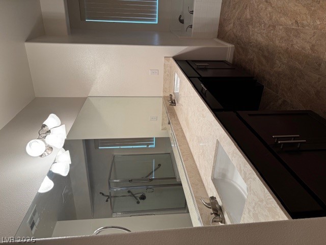 3744 River Heights Lane Logandale, NV 89021 - Photo 10 of 17 A well-appointed primary bathroom featuring dual sinks and an enclosed glass shower.